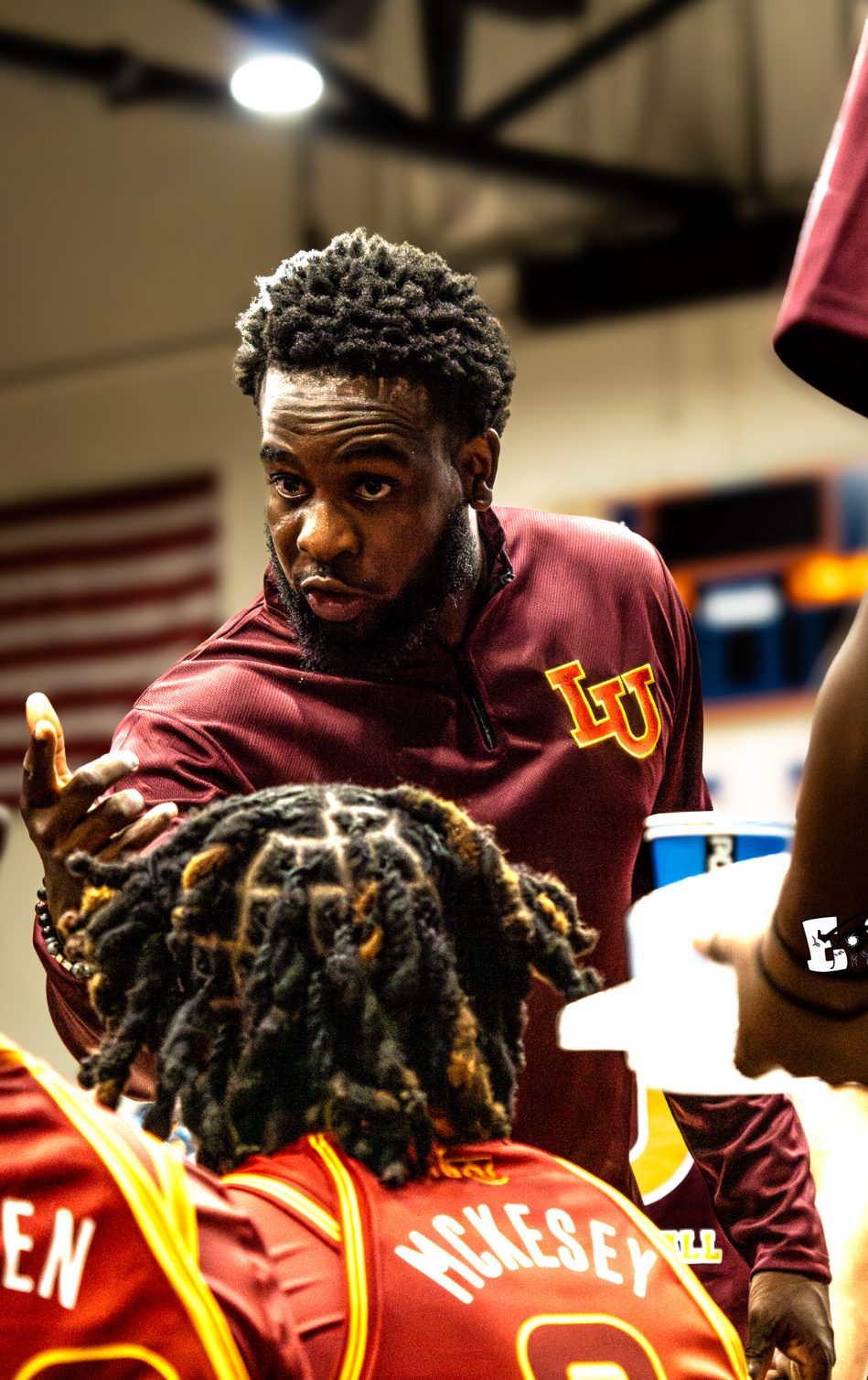 Lincoln University Oakland head coach in huddle with players